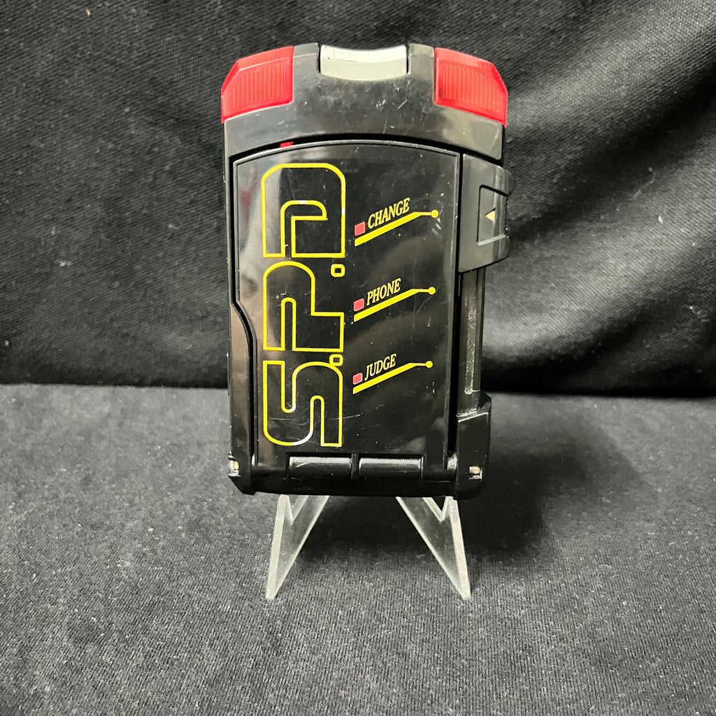 Collection of morphers and licenses from Power Rangers S.P.D. and Super Sentai Dekaranger: Delta Morphers, Red Ranger Morpher, SPD License, Dekamaster License, Patrol Morpher, and Morpher SPD.