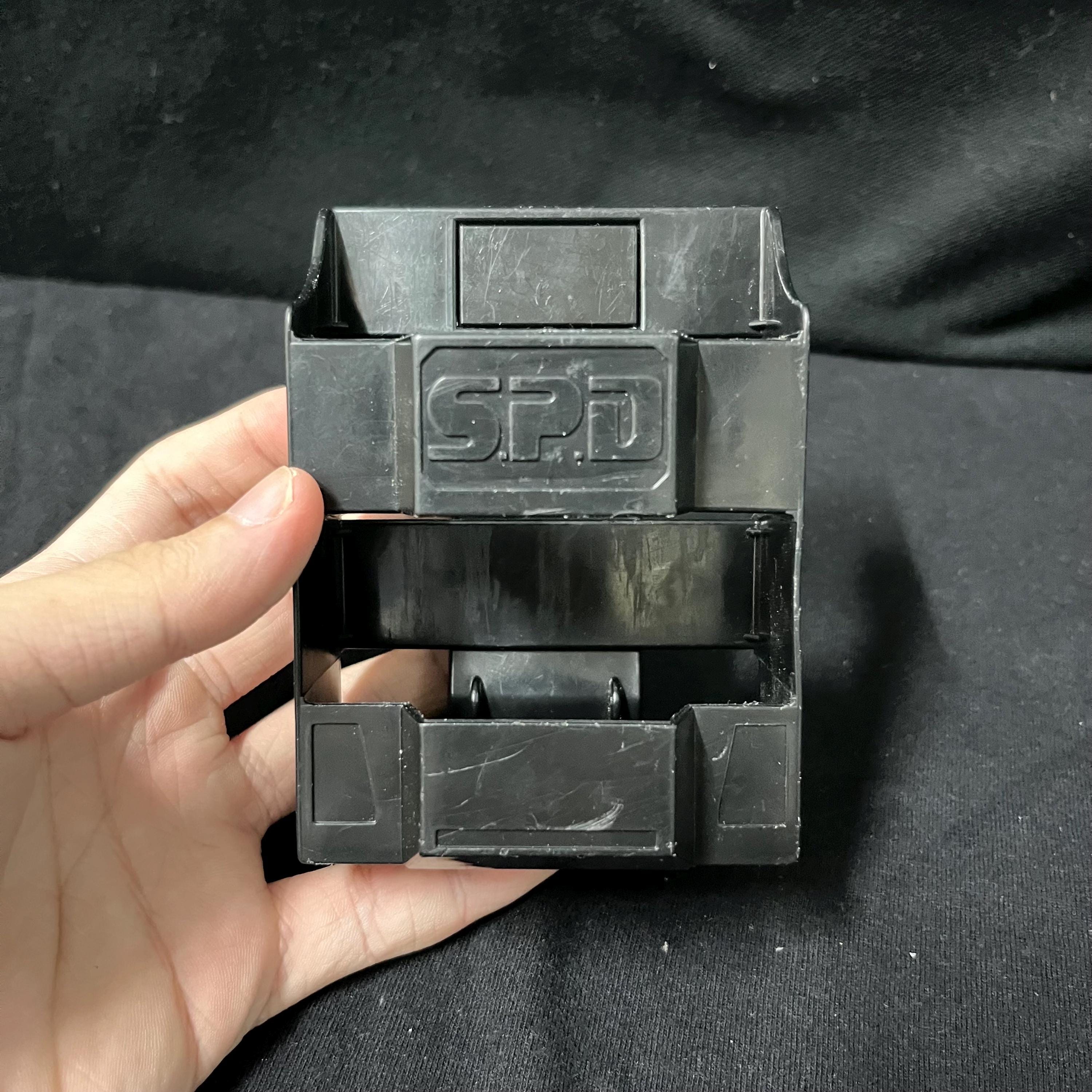Collection of morphers and licenses from Power Rangers S.P.D. and Super Sentai Dekaranger: Delta Morphers, Red Ranger Morpher, SPD License, Dekamaster License, Patrol Morpher, and Morpher SPD.